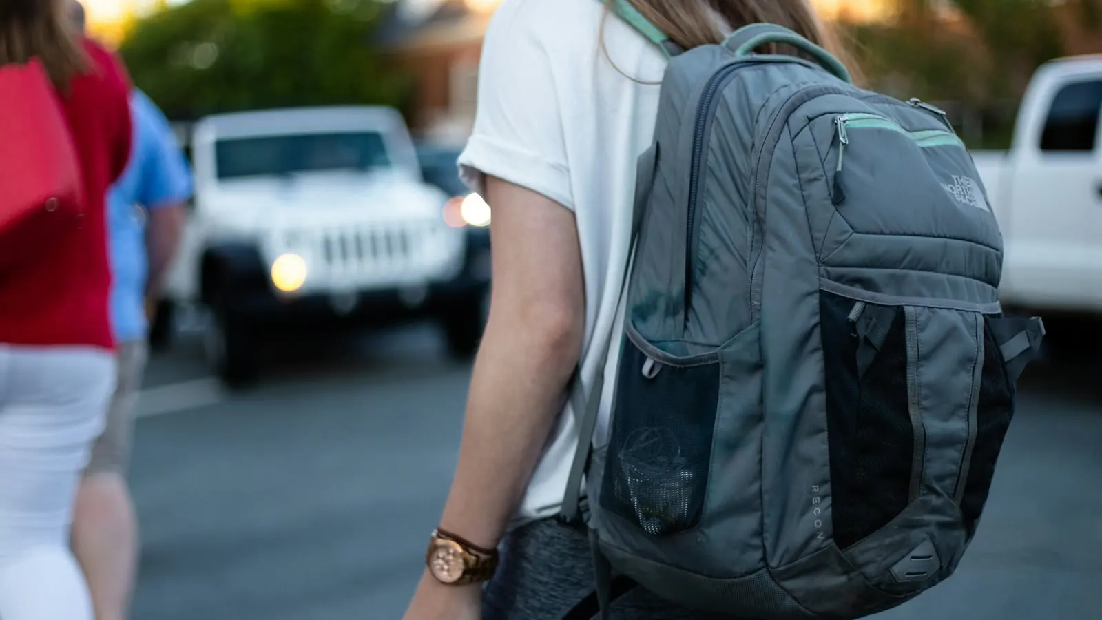 A student wearing a backpack on the way to school