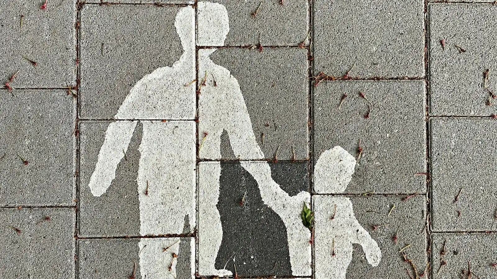 A painted family symbol on a pedestrian path