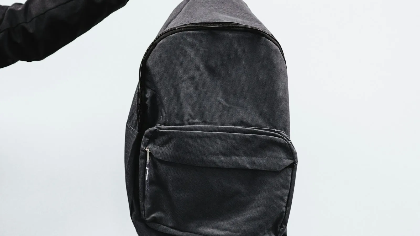 A black backpack ready for a move or journey