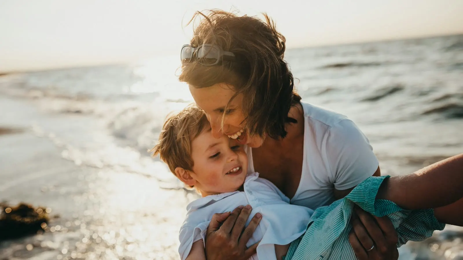 A parent comforting a young child outdoors