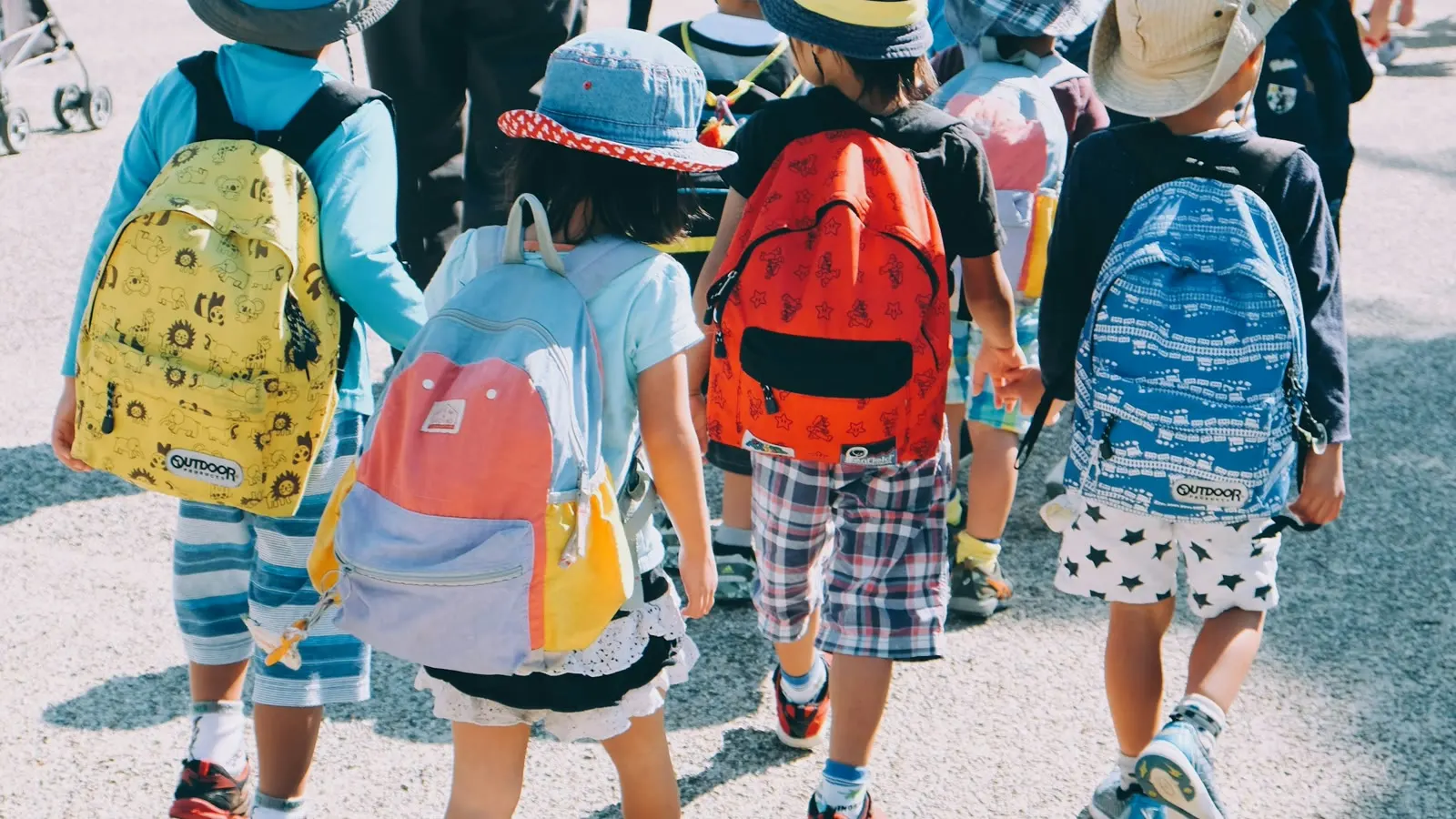 Children walking together with colorful backpacks